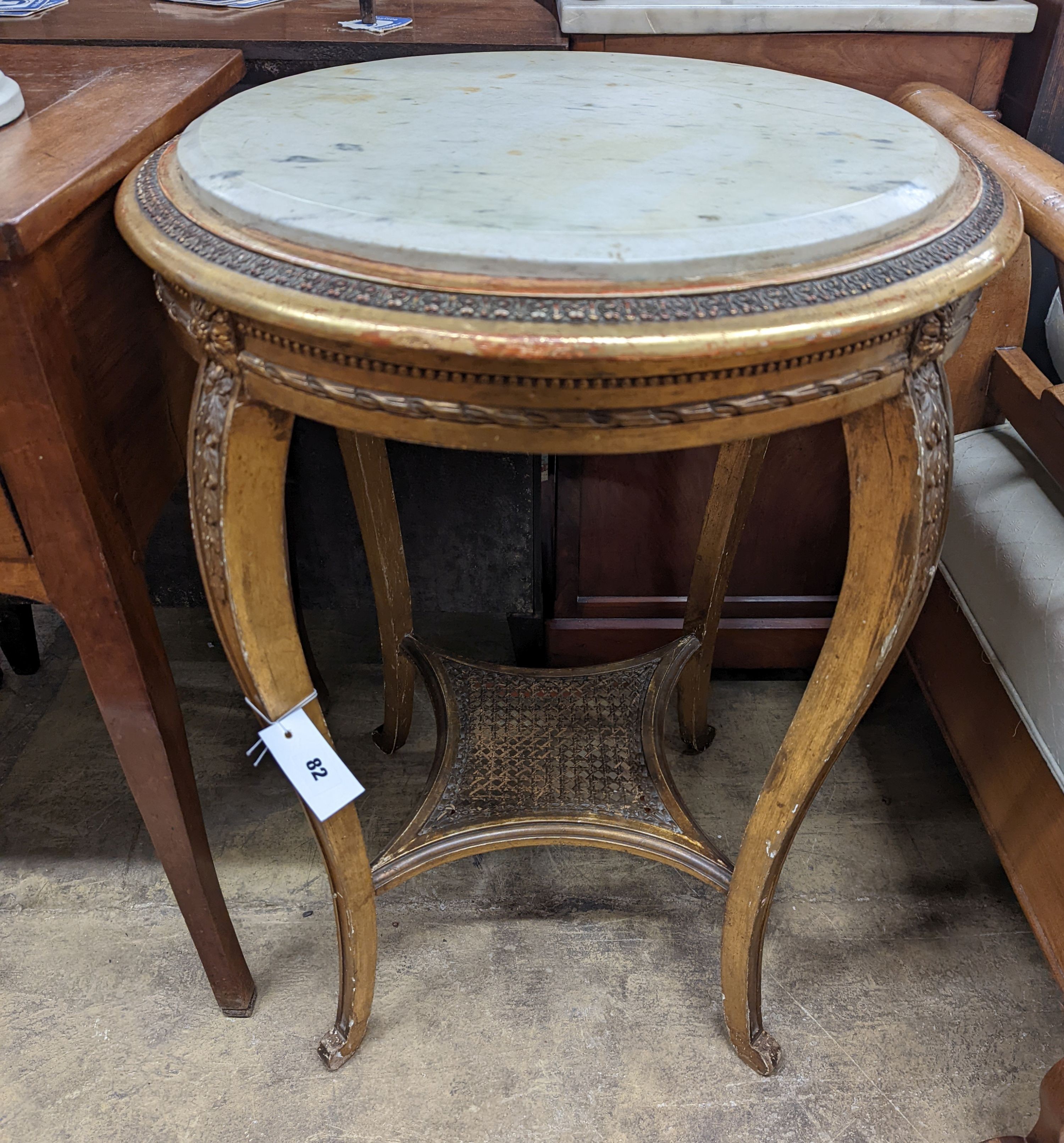 A French caned giltwood circular centre table with reconstituted marble top, diameter 55cm, height 76cm